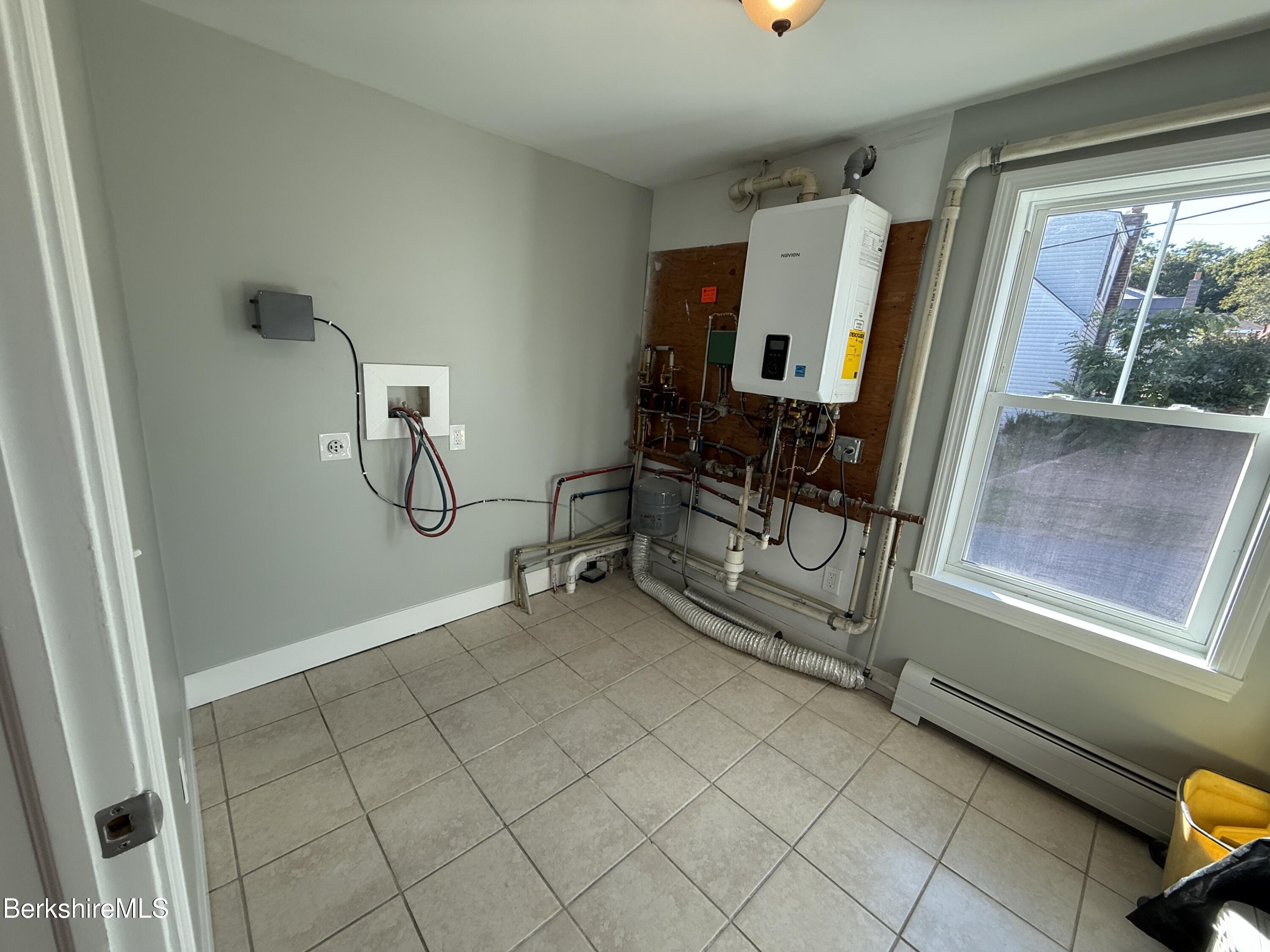 17 Elm Street, Unit A Adams, MA 01220 - Photo 7 of 17 a view of a room with rack on the wall and a window