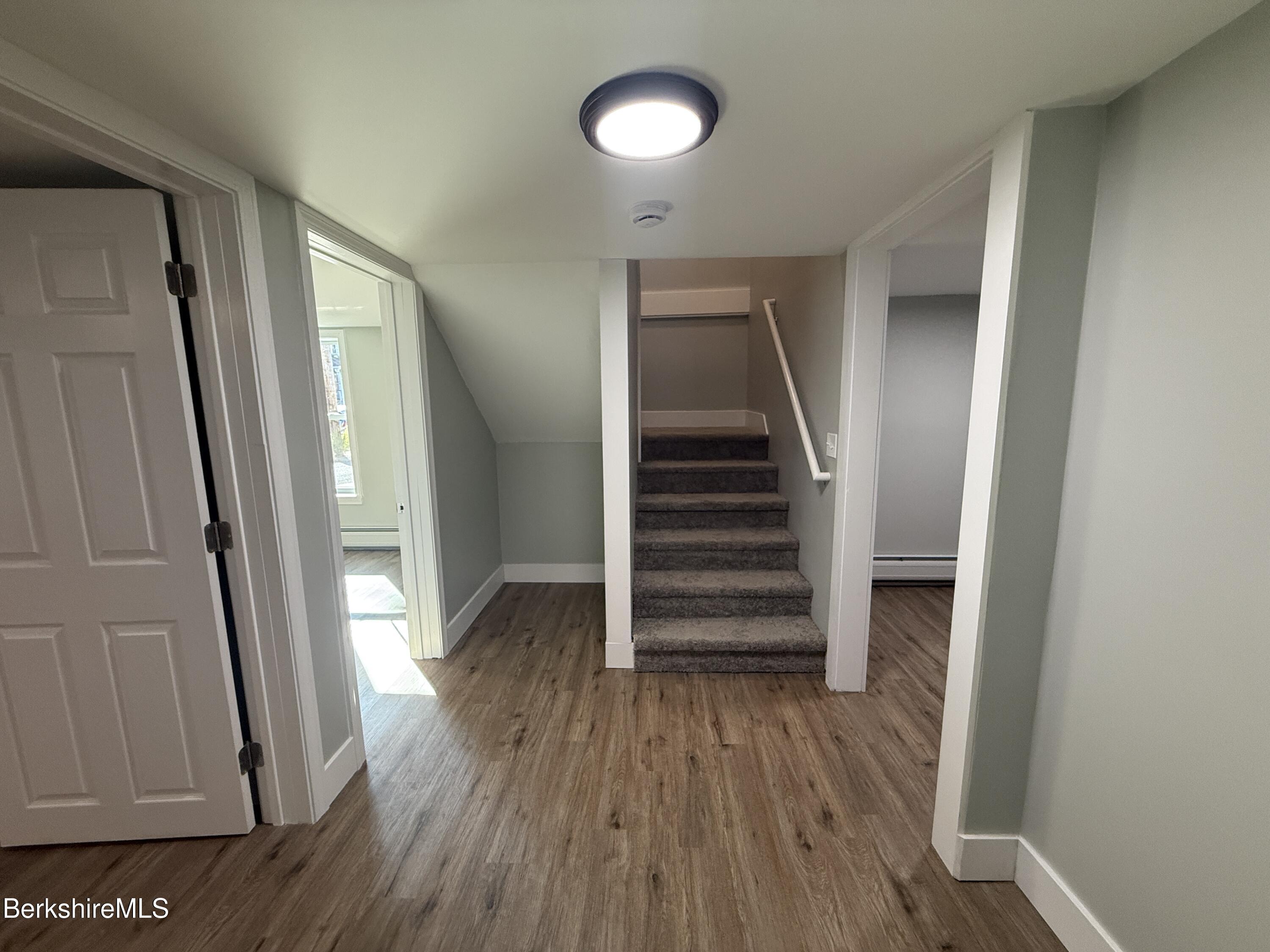 17 Elm Street, Unit A Adams, MA 01220 - Photo 10 of 17 a view of a hallway with wooden floor and stairs