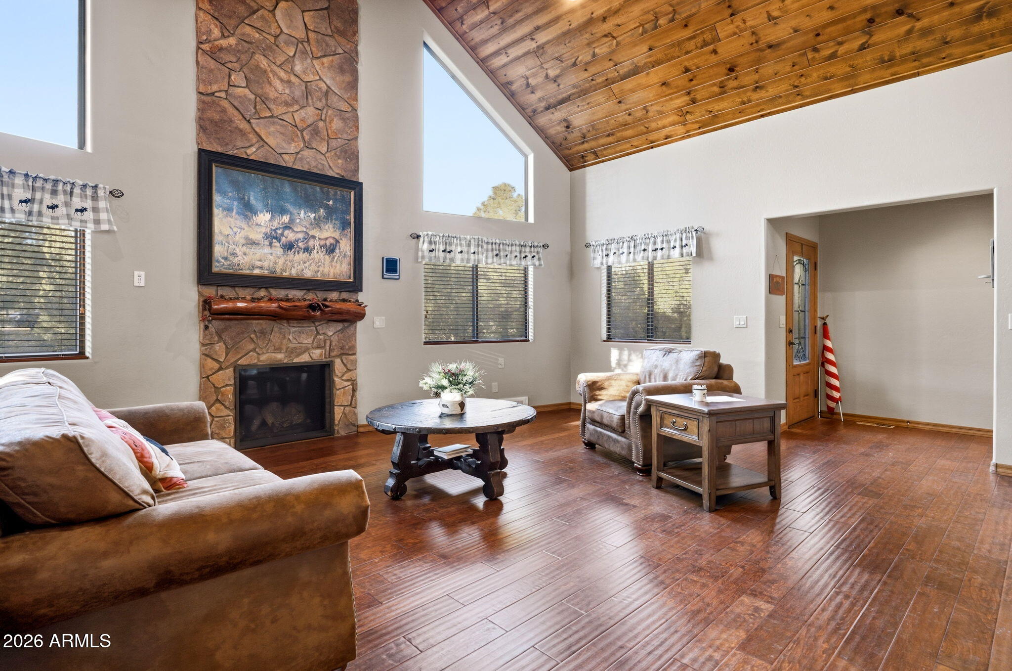 2750 Columbia Lane Overgaard, AZ 85933 - Photo 12 of 51 a living room with furniture a fireplace and a table