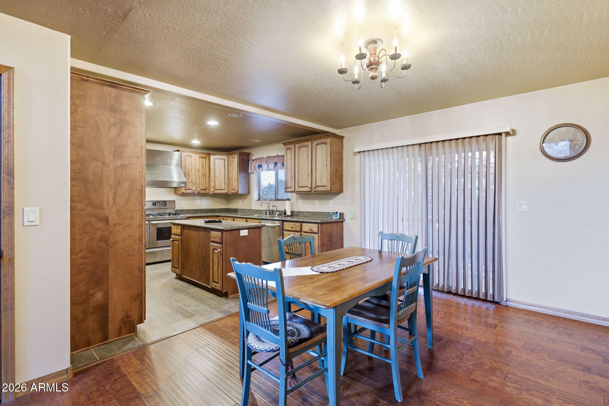 2750 Columbia Lane Overgaard, AZ 85933 - Photo 16 of 51 a kitchen with a dining table chairs refrigerator and cabinets