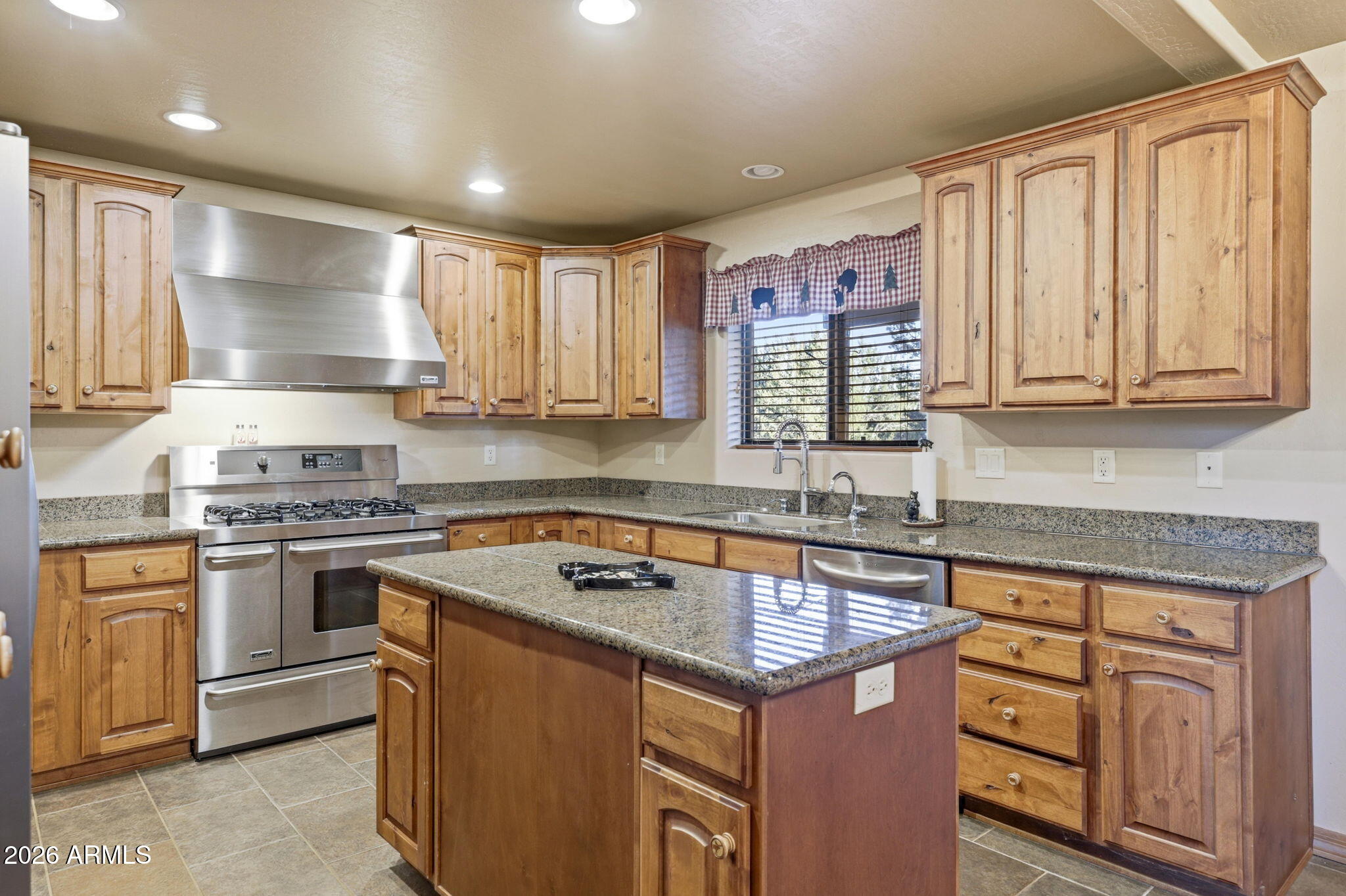 2750 Columbia Lane Overgaard, AZ 85933 - Photo 17 of 51 a kitchen with kitchen island granite countertop a sink cabinets stainless steel appliances and a window