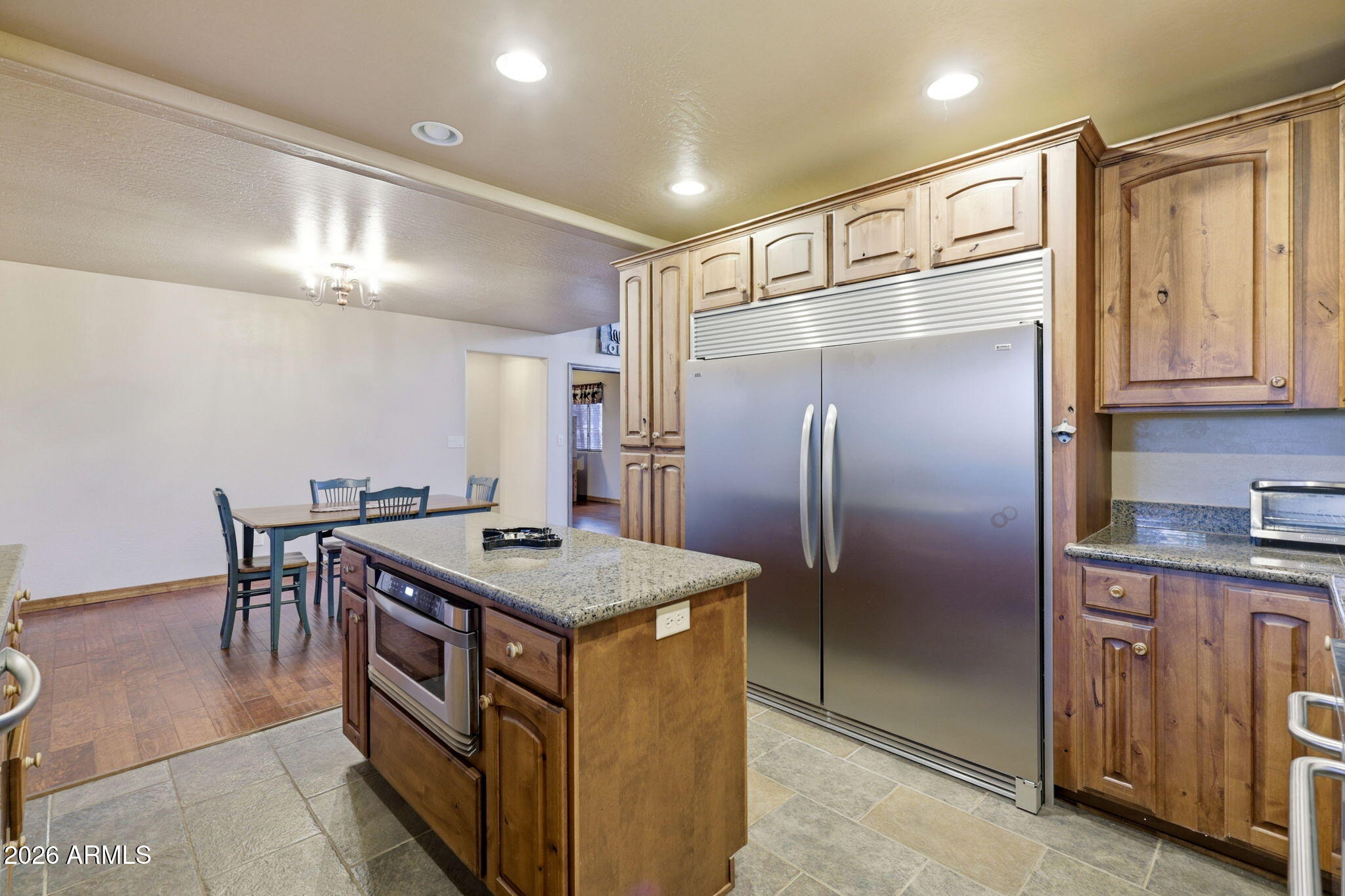 2750 Columbia Lane Overgaard, AZ 85933 - Photo 19 of 51 a kitchen with kitchen island a counter top space cabinets and stainless steel appliances