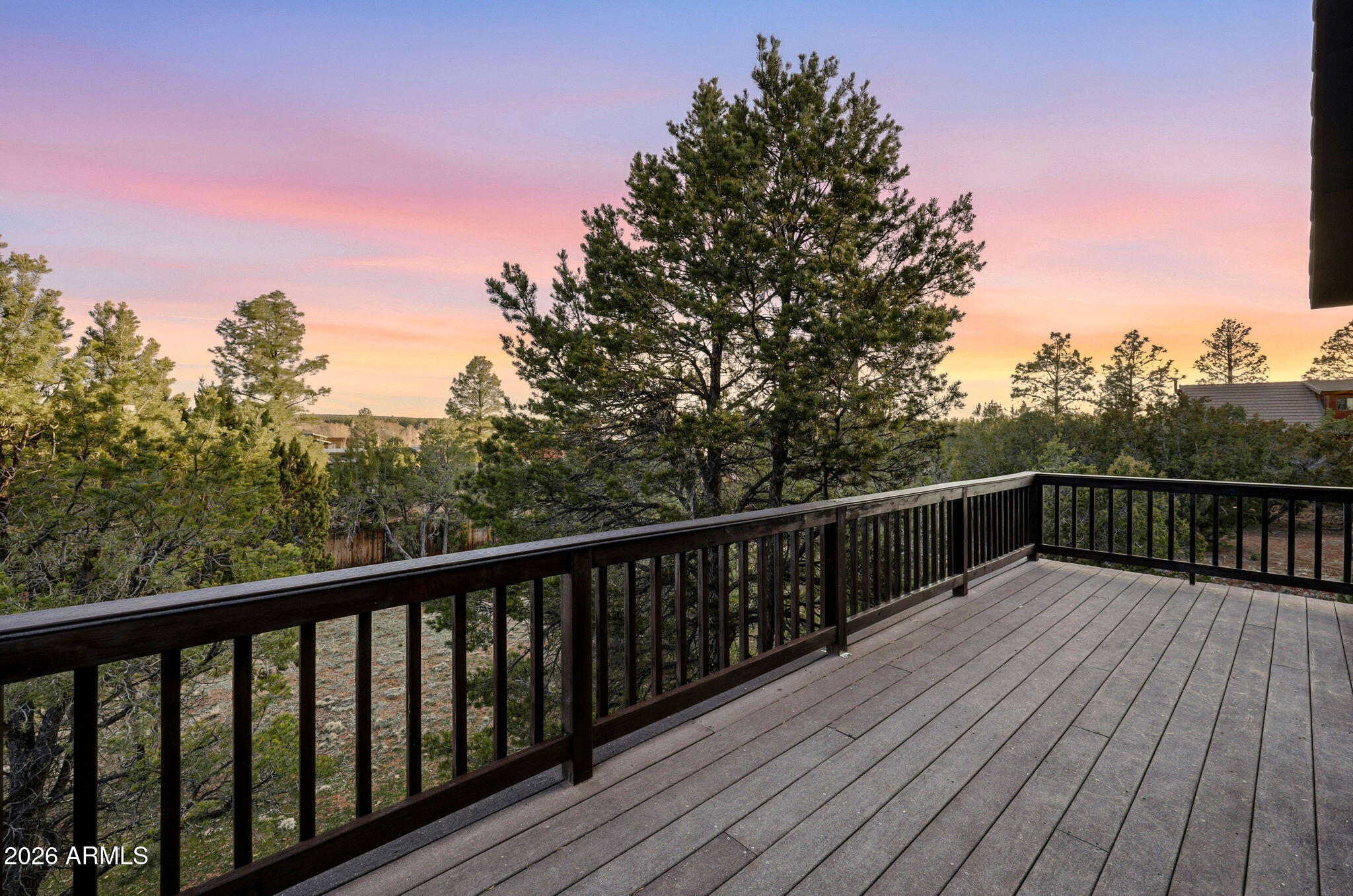 2750 Columbia Lane Overgaard, AZ 85933 - Photo 30 of 51 a balcony with wooden floor and trees in the background