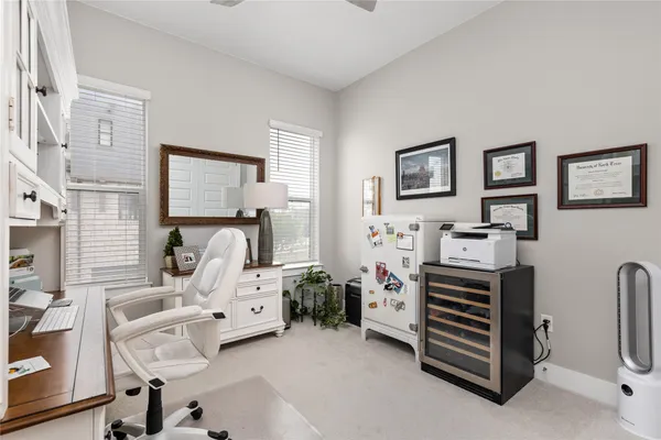 a kitchen with sink a refrigerator and cabinets