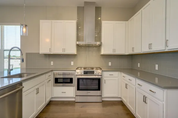 a view of a hallway with closet and wooden floor