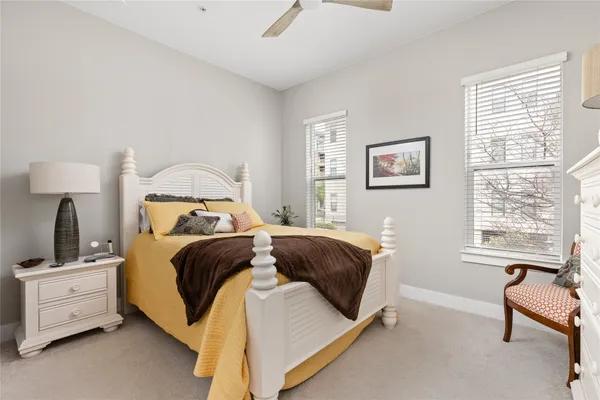 a kitchen with stainless steel appliances kitchen island granite countertop a table chairs sink and cabinets