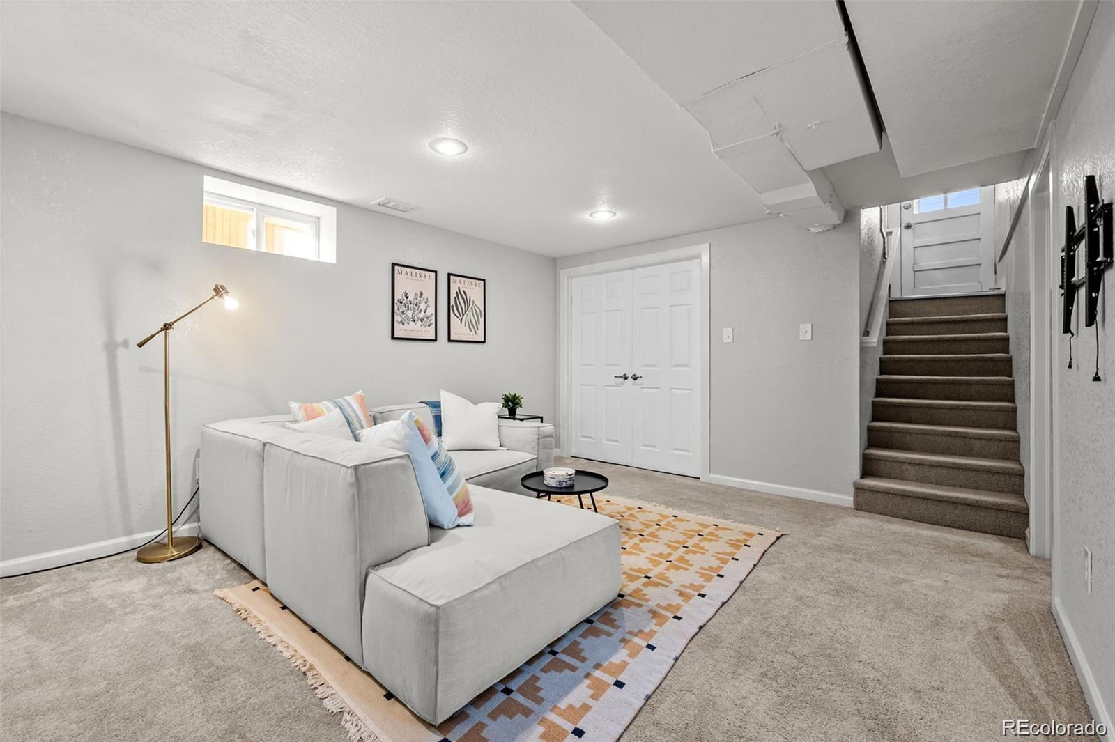 3649 Garfield Street Denver, CO 80205 - Photo 17 of 30 a living room with furniture and a rug