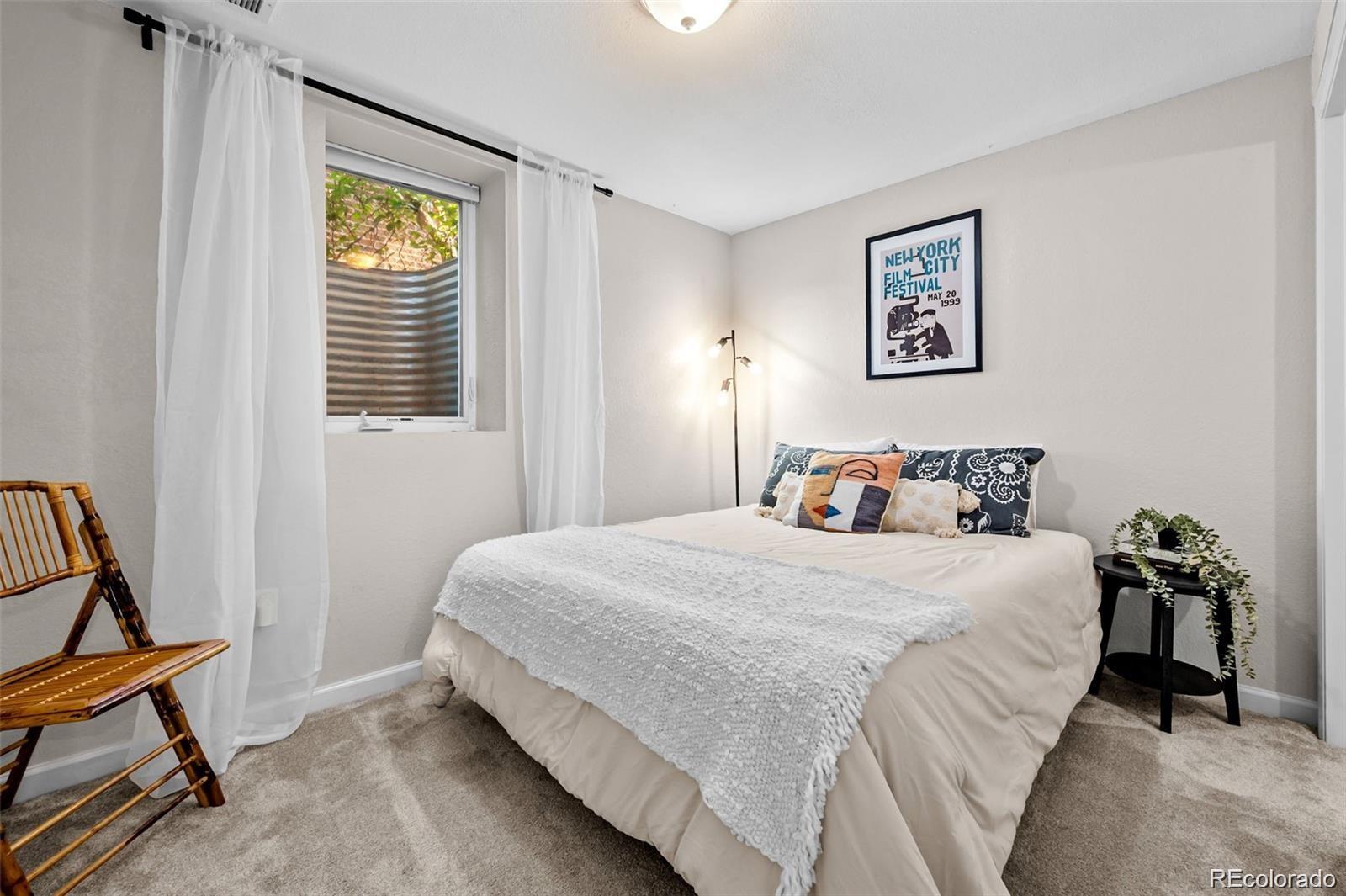 3649 Garfield Street Denver, CO 80205 - Photo 19 of 30 a bedroom with a bed and a window