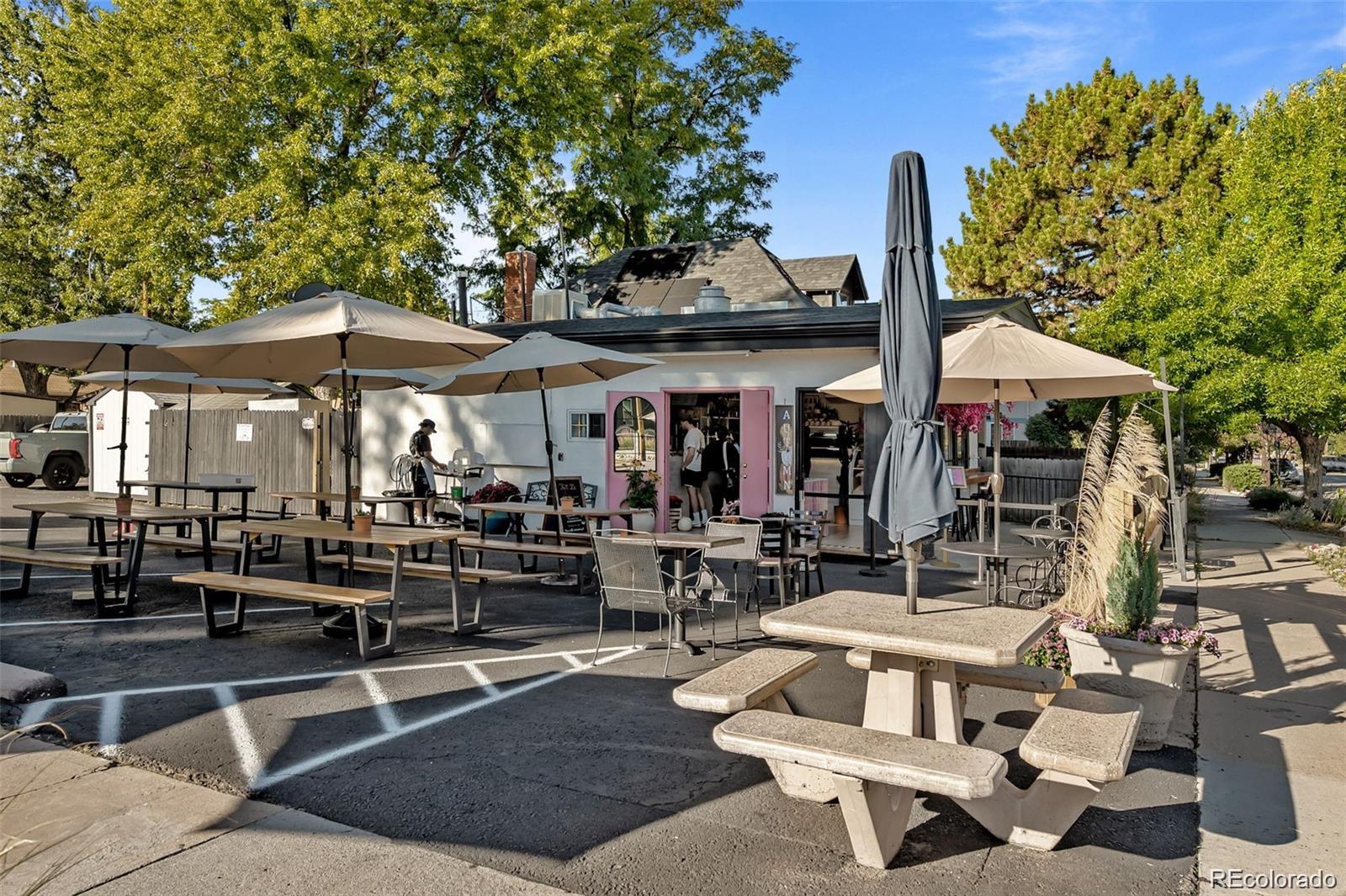 3649 Garfield Street Denver, CO 80205 - Photo 29 of 30 a view of a patio with table and chairs under an umbrella