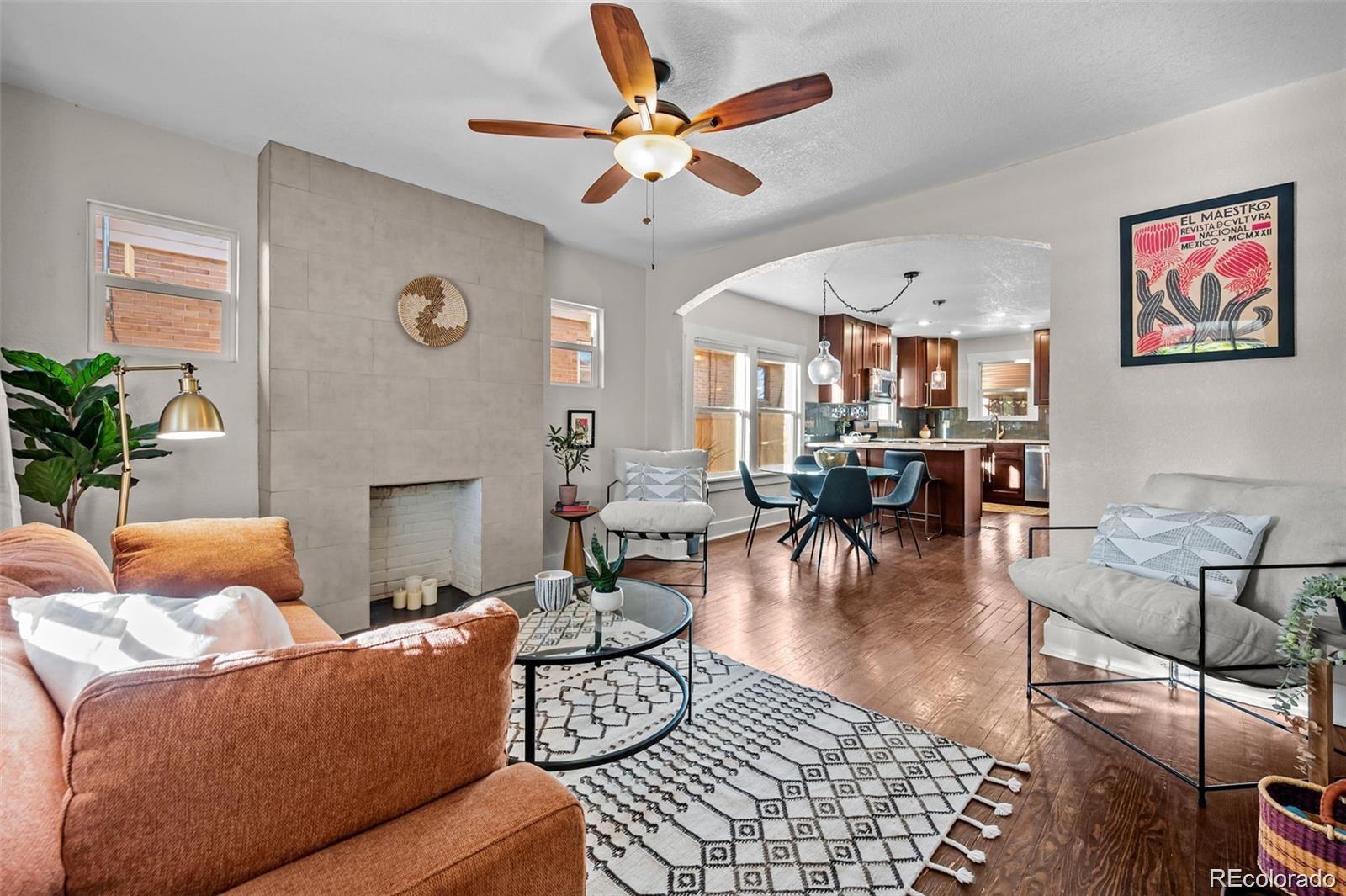 3649 Garfield Street Denver, CO 80205 - Photo 4 of 30 a living room with furniture kitchen view and a chandelier