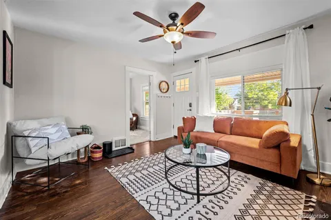 a living room with furniture a table and a large window