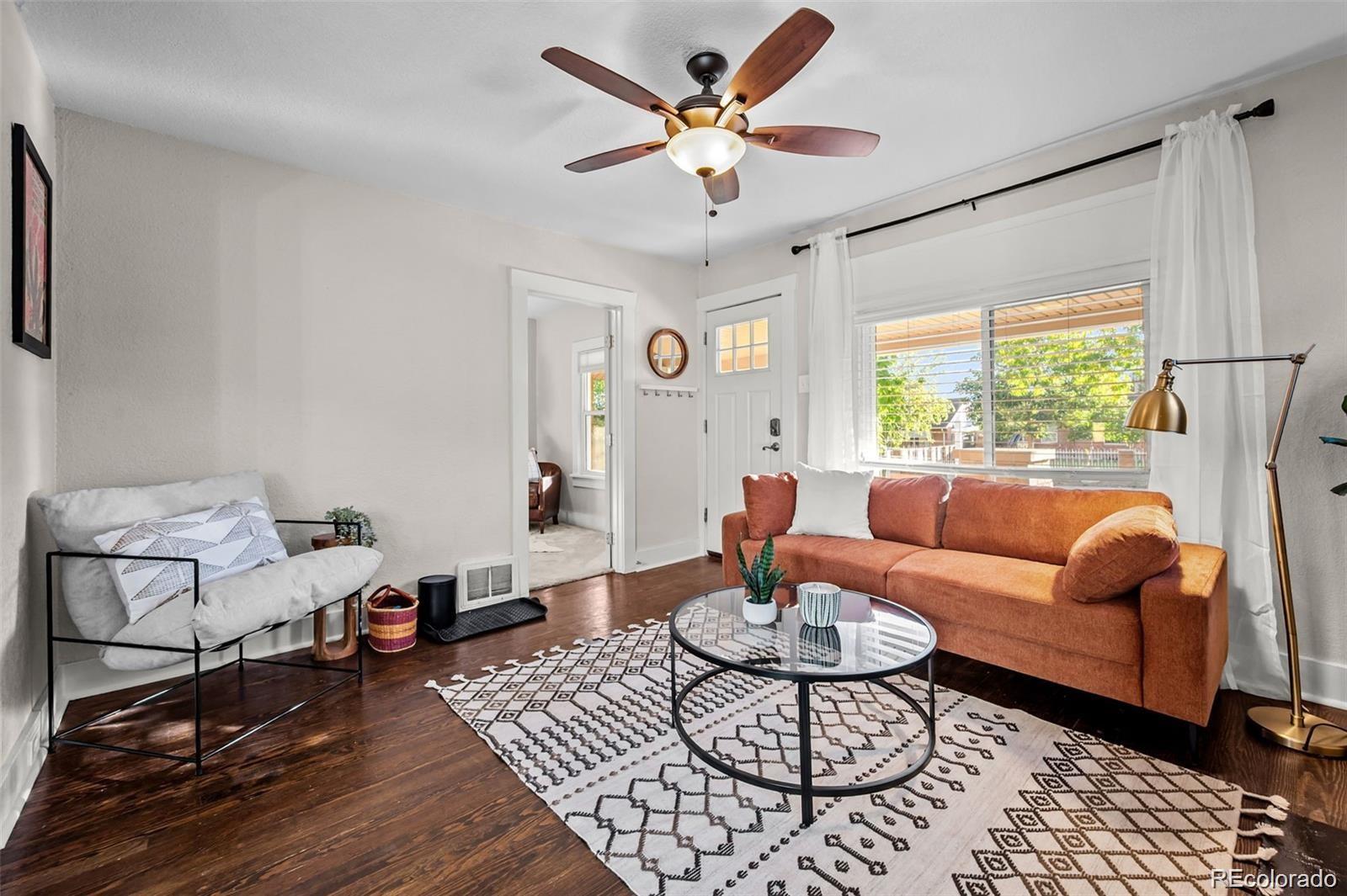 3649 Garfield Street Denver, CO 80205 - Photo 6 of 30 a living room with furniture a table and a large window