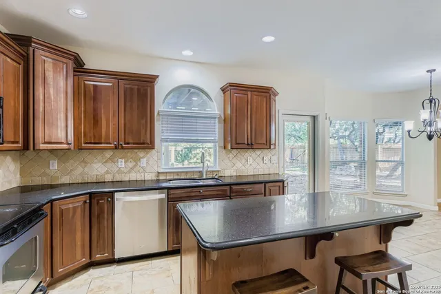 a kitchen with a sink window and cabinets