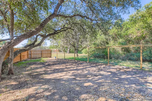 a view of a yard with a tree