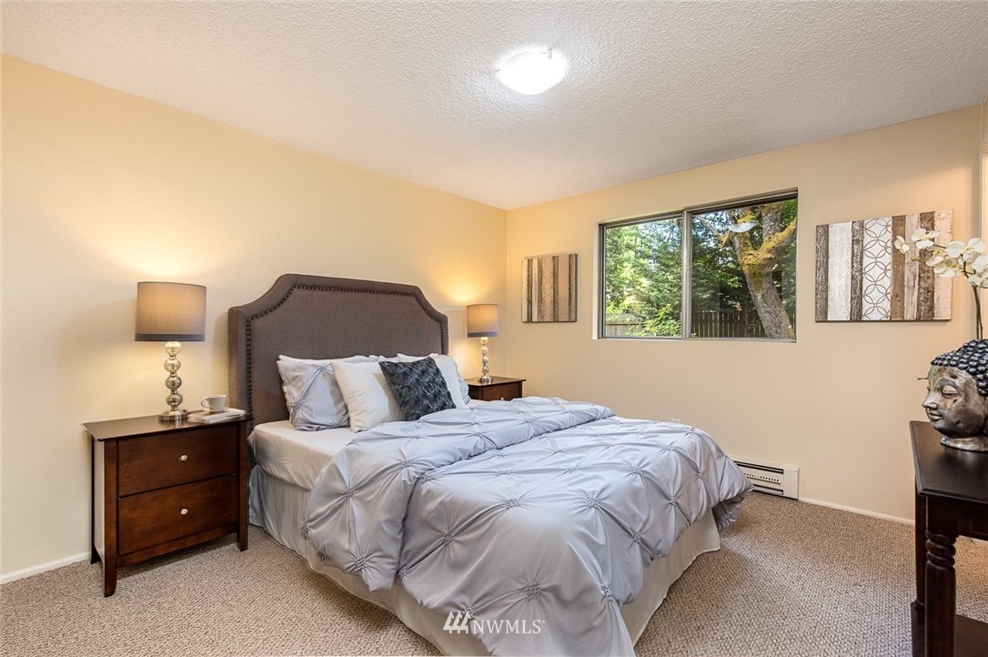 10044 Slater Avenue Northeast Kirkland, WA 98033 - Photo 12 of 21 a bedroom with a bed and a night stand
