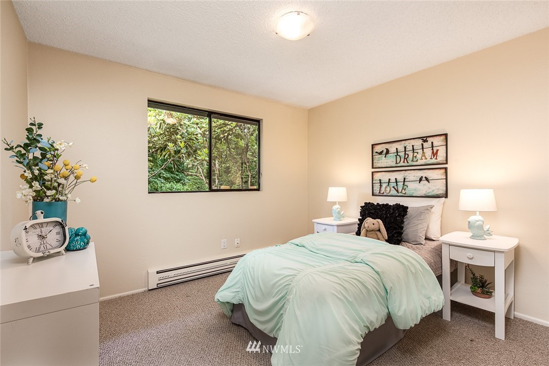 10044 Slater Avenue Northeast Kirkland, WA 98033 - Photo 13 of 21 a bedroom with a bed and a potted plant
