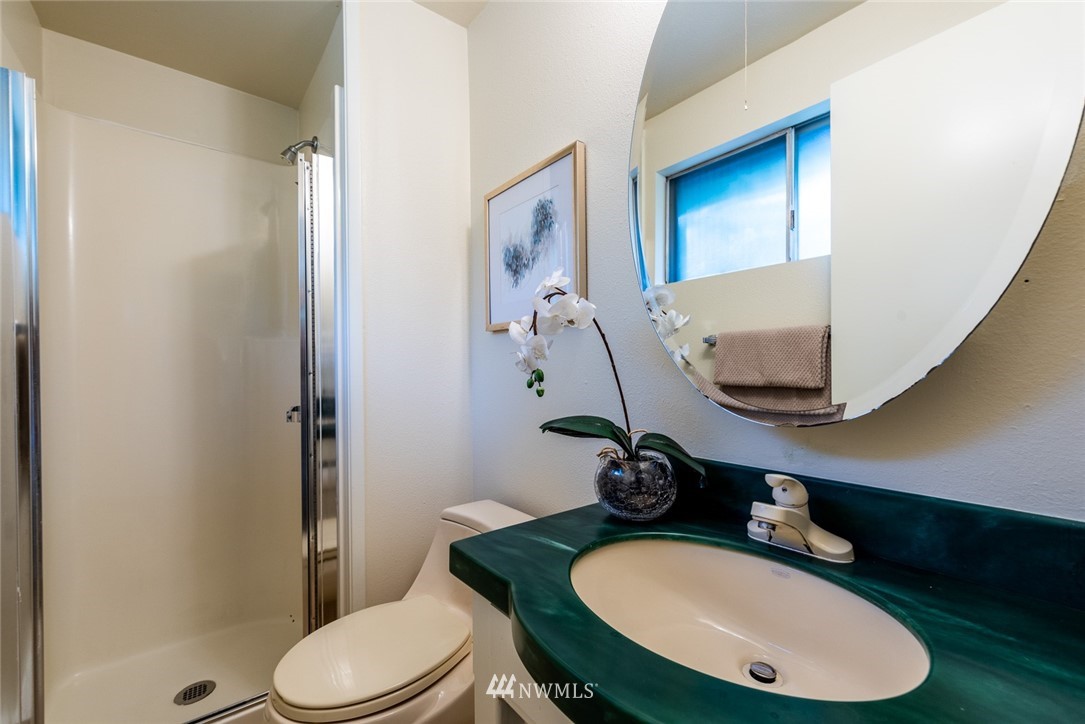 10044 Slater Avenue Northeast Kirkland, WA 98033 - Photo 16 of 21 a bathroom with a granite countertop toilet sink and mirror