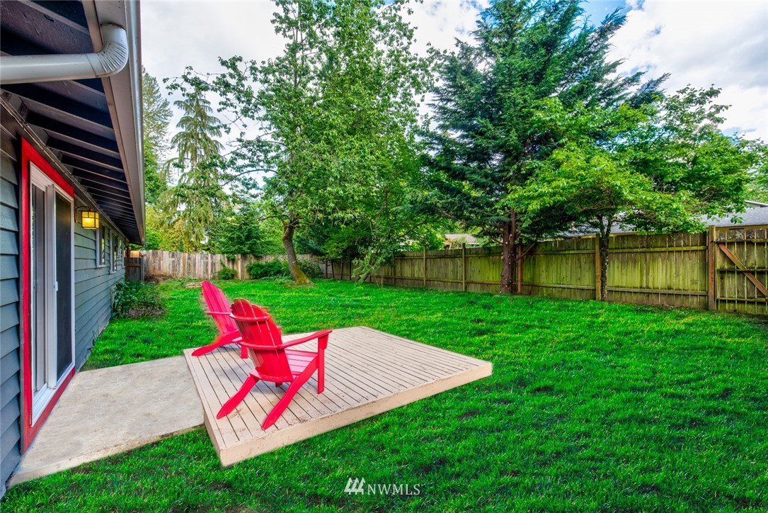 10044 Slater Avenue Northeast Kirkland, WA 98033 - Photo 20 of 21 a view of a chair and table on the green yard
