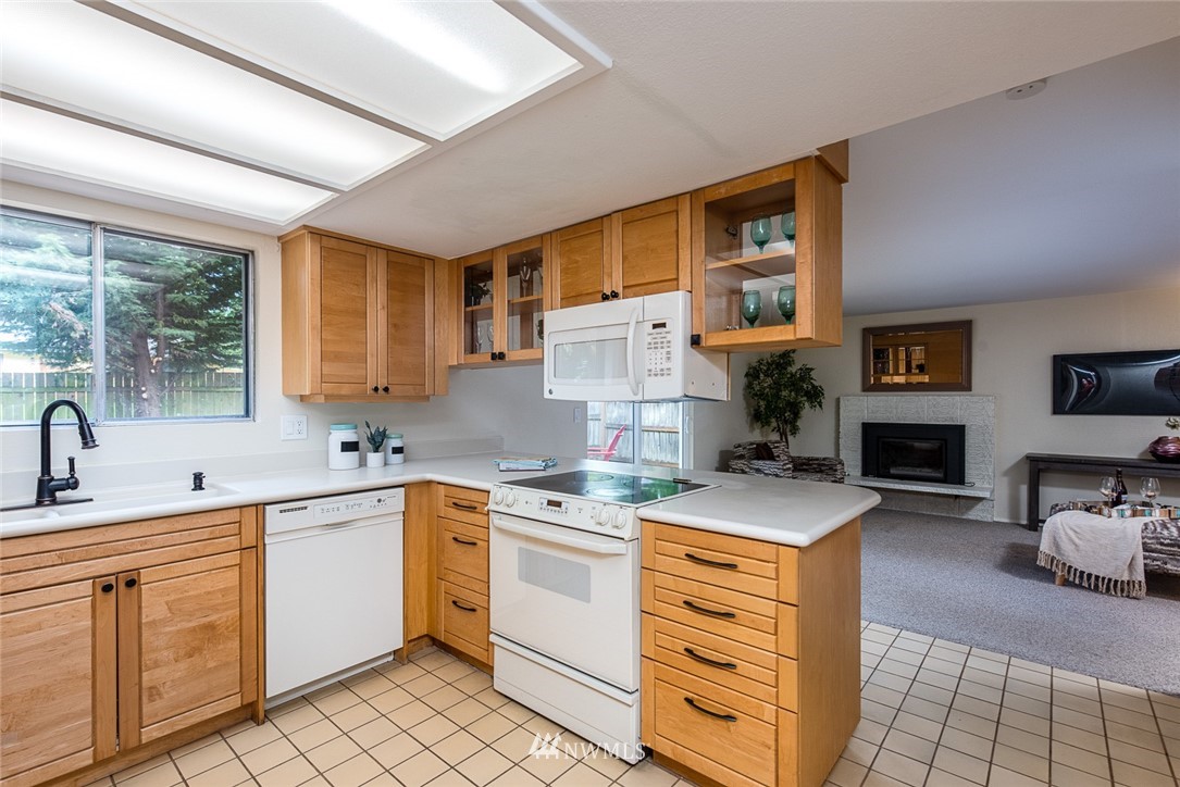 10044 Slater Avenue Northeast Kirkland, WA 98033 - Photo 6 of 21 a kitchen with a sink stove and cabinets