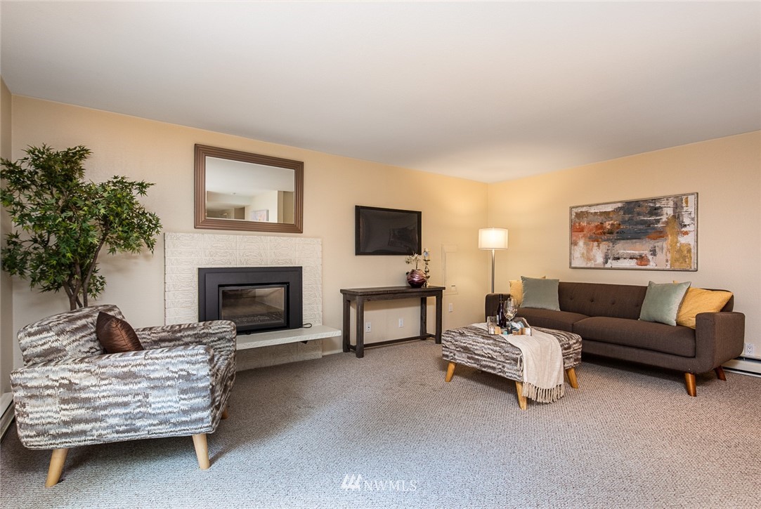 10044 Slater Avenue Northeast Kirkland, WA 98033 - Photo 10 of 21 a living room with furniture and a fireplace