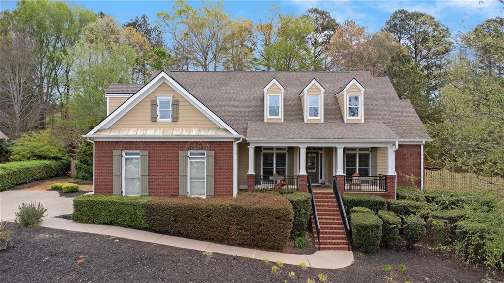 35 Waterstone Drive Southeast Cartersville, GA 30121 - Photo 2 of 58 a view of a brick house with a yard plants and large tree