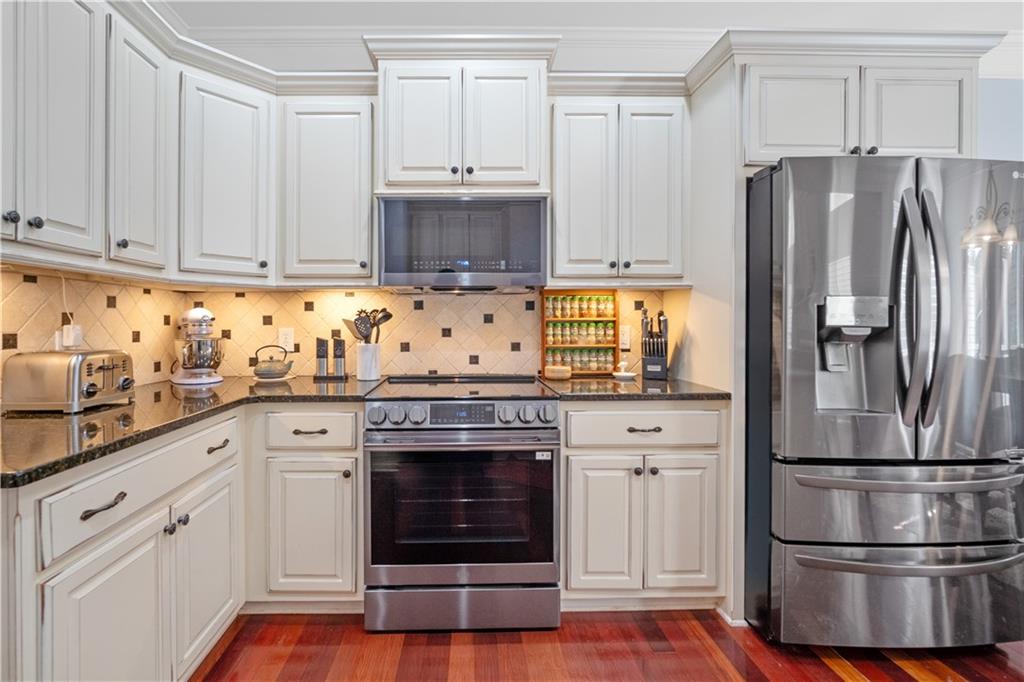 35 Waterstone Drive Southeast Cartersville, GA 30121 - Photo 22 of 58 a kitchen with cabinets stainless steel appliances and wooden floor