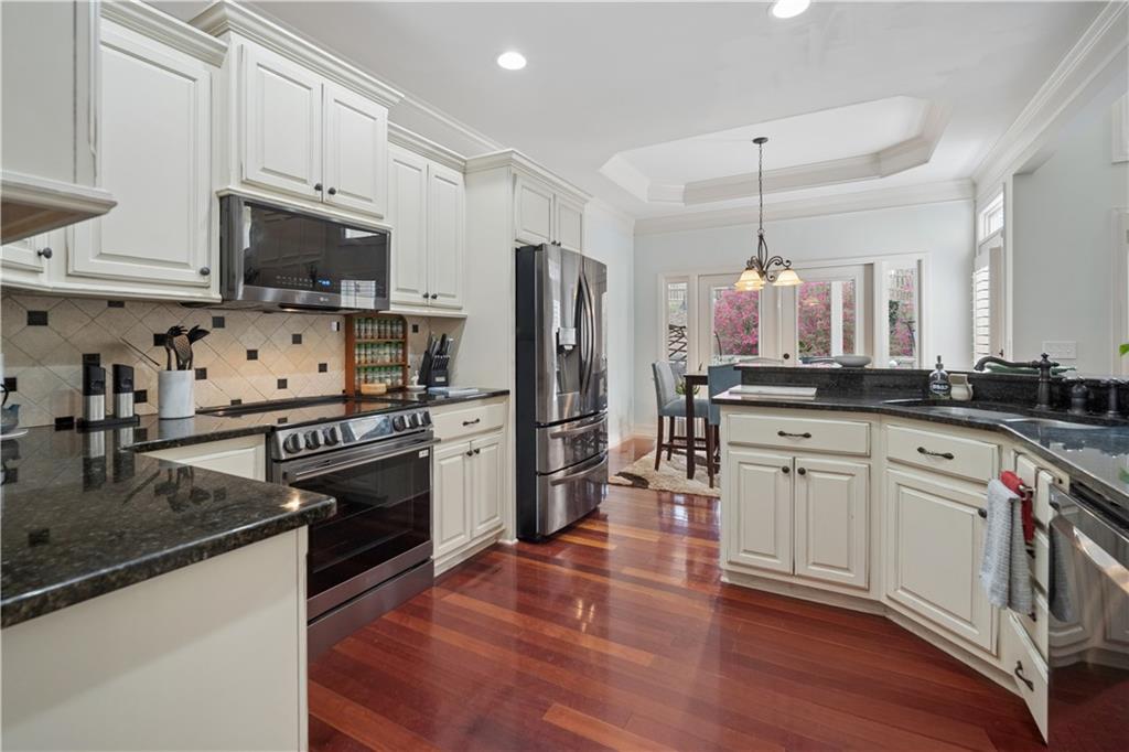 35 Waterstone Drive Southeast Cartersville, GA 30121 - Photo 24 of 58 a kitchen with stainless steel appliances a stove refrigerator sink and microwave