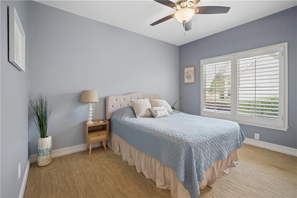 35 Waterstone Drive Southeast Cartersville, GA 30121 - Photo 35 of 58 a bedroom with a bed and a chandelier