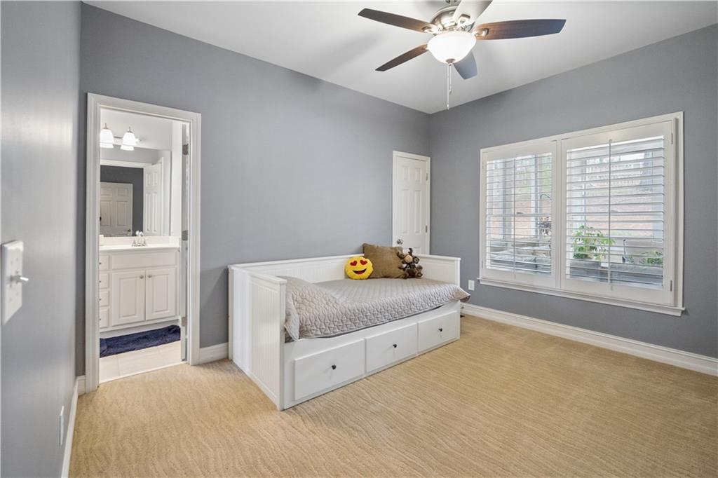 35 Waterstone Drive Southeast Cartersville, GA 30121 - Photo 37 of 58 a spacious bedroom with a bed and a chandelier