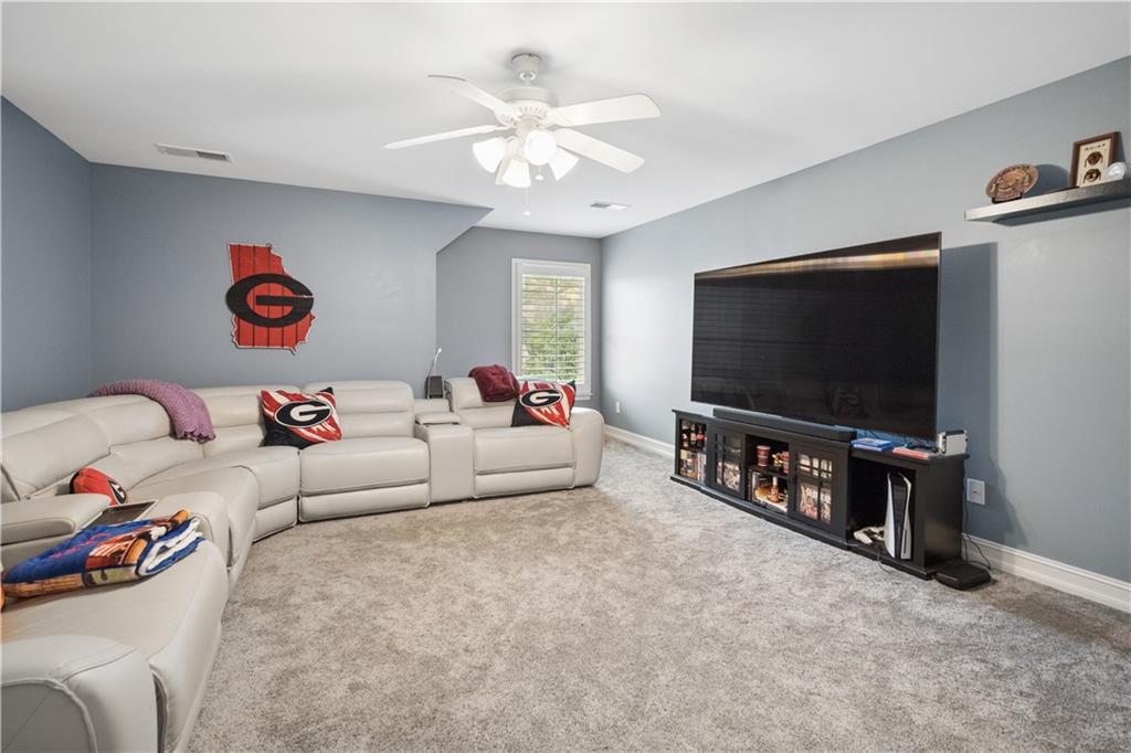 35 Waterstone Drive Southeast Cartersville, GA 30121 - Photo 39 of 58 a living room with furniture and a flat screen tv