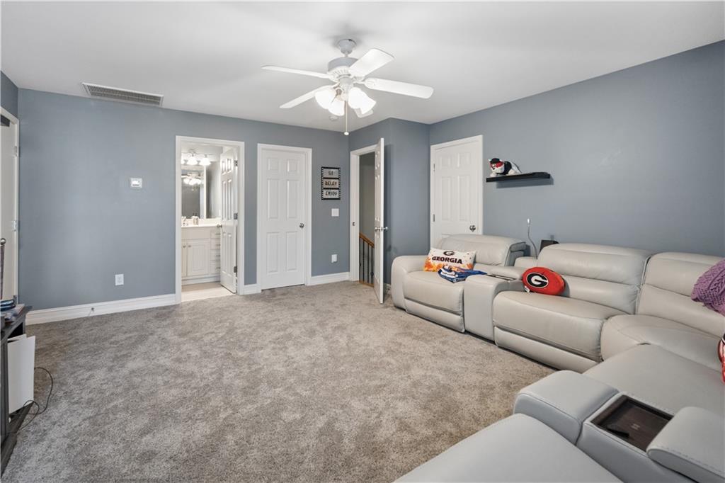 35 Waterstone Drive Southeast Cartersville, GA 30121 - Photo 40 of 58 a living room with furniture and a chandelier