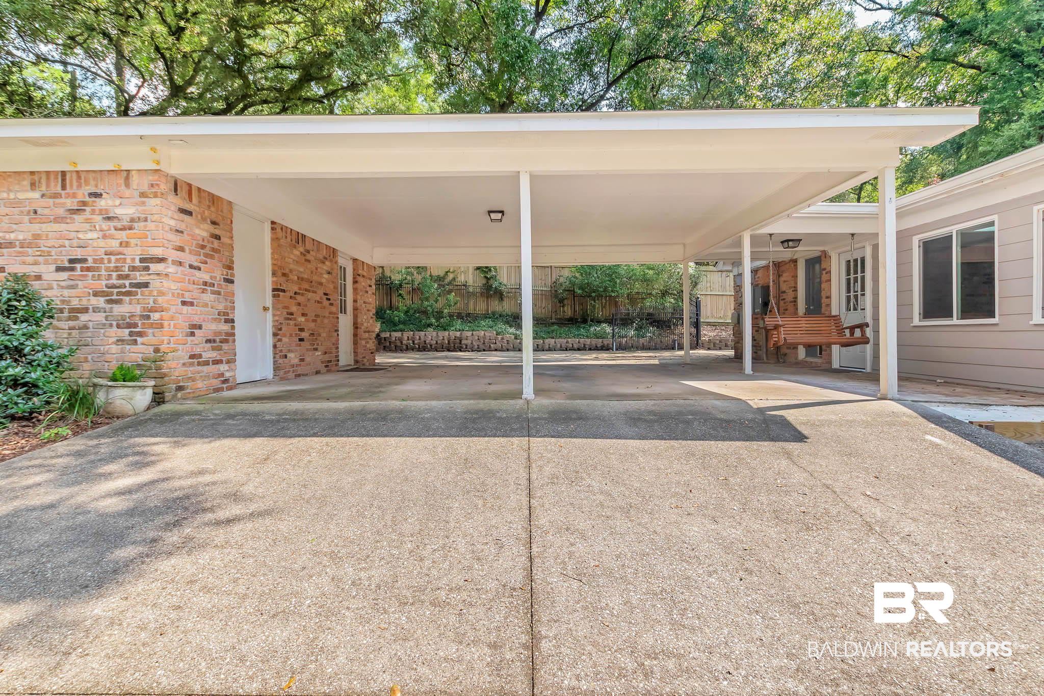309 West Brandy Run Road Mobile, AL 36608 - Photo 85 of 100 View of vehicle parking featuring concrete driveway and an attached carport