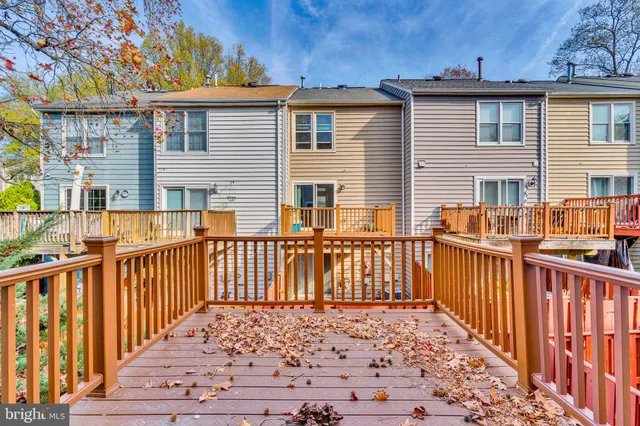 a view of a house with wooden fence