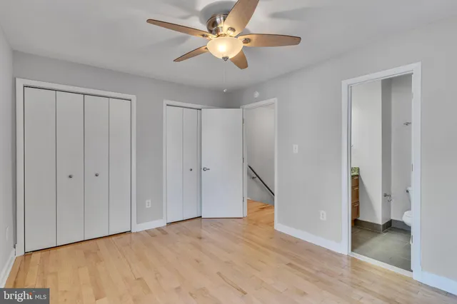 a view of an empty room with a ceiling fan