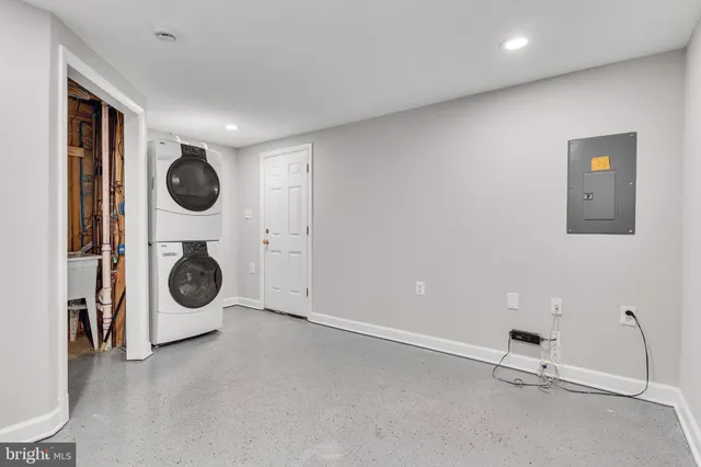 a view of a storage & utility room with two washing machine