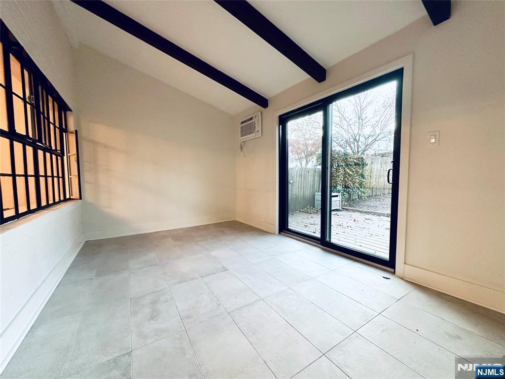 355 Valley Boulevard Wood-Ridge, NJ 07075 - Photo 11 of 24 a view of an empty room with wooden floor and windows