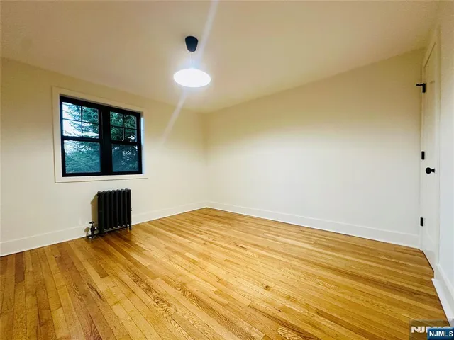 a view of a room with wooden floor and windows