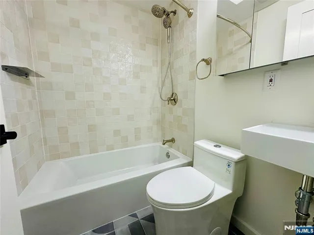 a bathroom with a sink toilet and bathtub