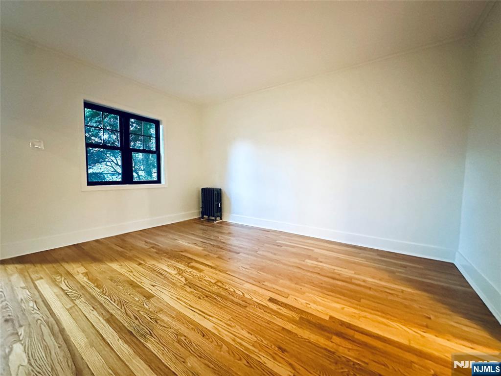355 Valley Boulevard Wood-Ridge, NJ 07075 - Photo 4 of 24 a view of empty room with wooden floor and fan