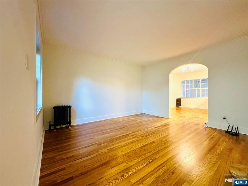 355 Valley Boulevard Wood-Ridge, NJ 07075 - Photo 5 of 24 a view of an empty room with wooden floor and a window