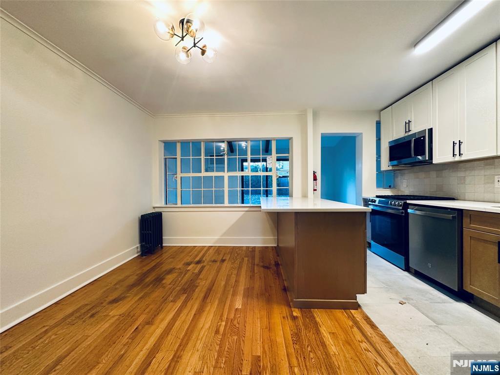 355 Valley Boulevard Wood-Ridge, NJ 07075 - Photo 6 of 24 a view of kitchen with wooden floor and electronic appliances