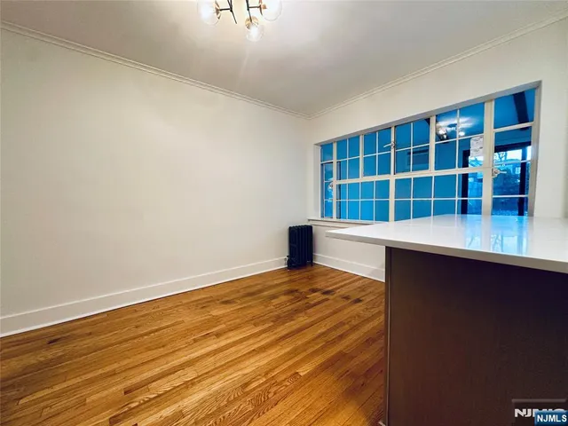 a view of a room with wooden floor and windows