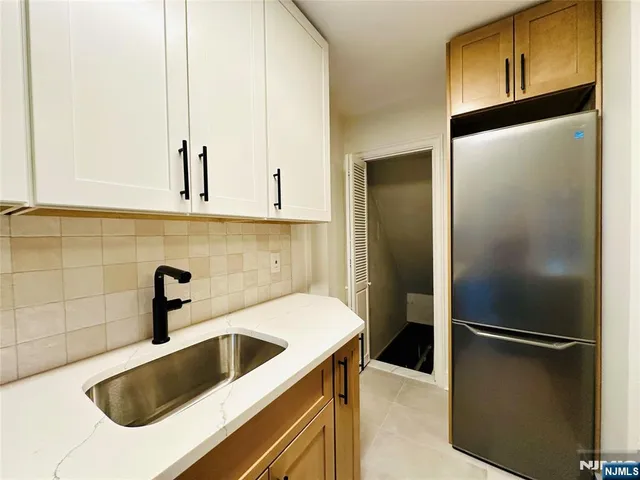 a kitchen with a sink and refrigerator
