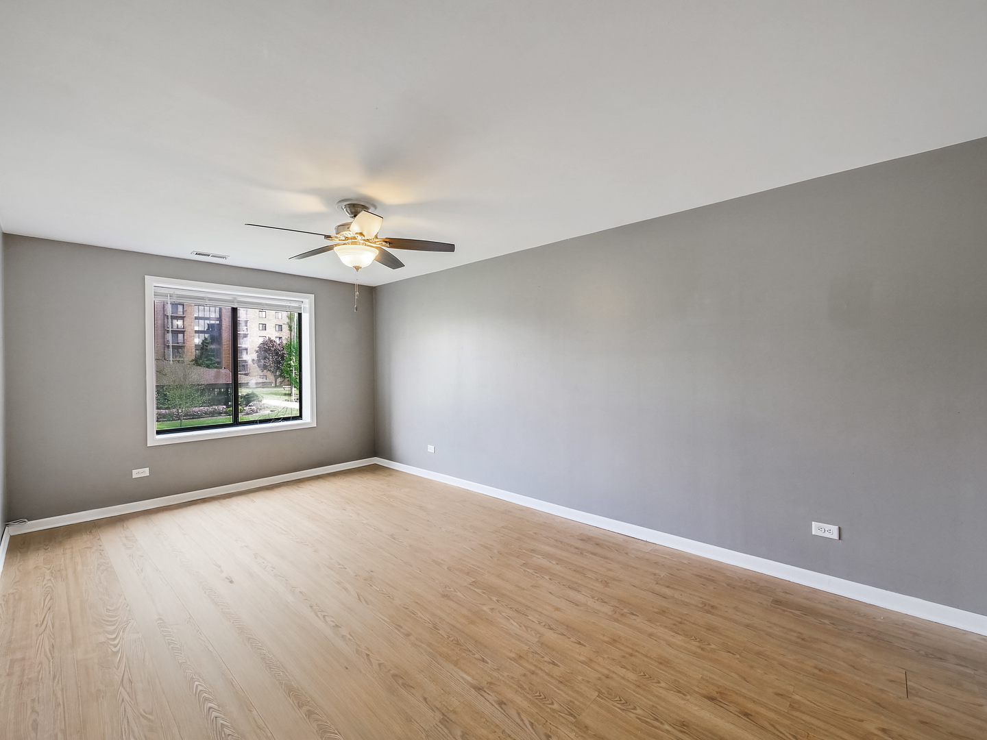1747 West Crystal Lane, Unit 210 Mount Prospect, IL 60056 - Photo 11 of 33 a view of an empty room with a window and a chandelier fan