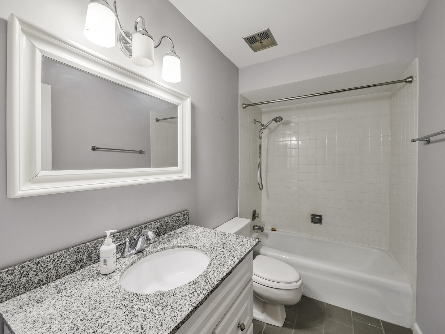 1747 West Crystal Lane, Unit 210 Mount Prospect, IL 60056 - Photo 13 of 33 a bathroom with a granite countertop toilet a sink and a mirror