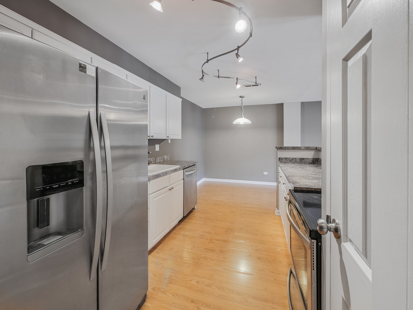 1747 West Crystal Lane, Unit 210 Mount Prospect, IL 60056 - Photo 17 of 33 a kitchen with stainless steel appliances granite countertop a refrigerator and a sink
