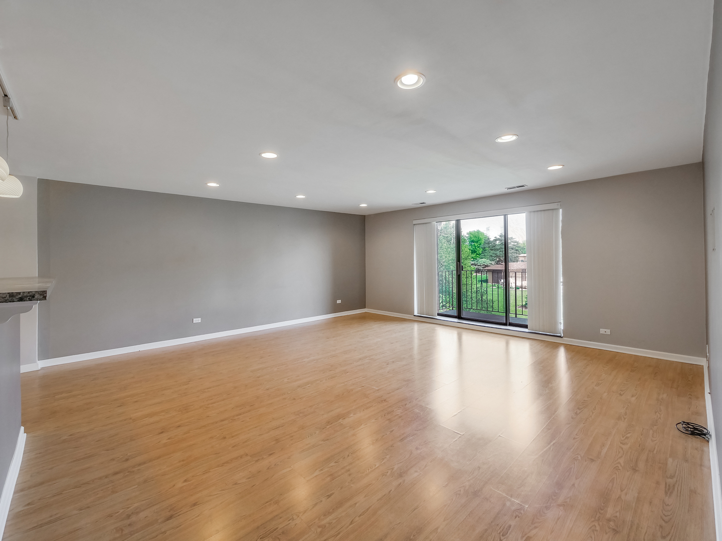 1747 West Crystal Lane, Unit 210 Mount Prospect, IL 60056 - Photo 20 of 33 a view of an empty room with wooden floor and a window