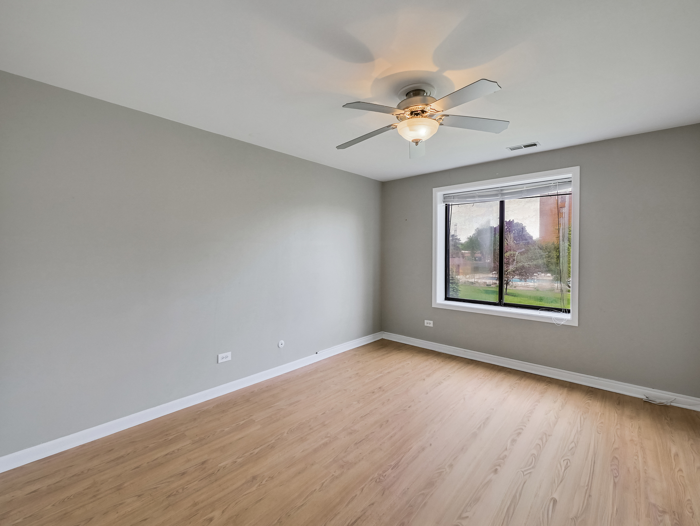 1747 West Crystal Lane, Unit 210 Mount Prospect, IL 60056 - Photo 23 of 33 wooden floor in an empty room with a window