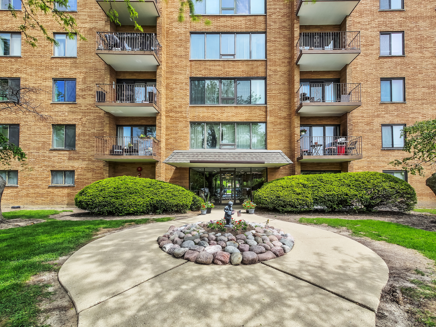 1747 West Crystal Lane, Unit 210 Mount Prospect, IL 60056 - Photo 4 of 33 a view of a brick building next to a yard