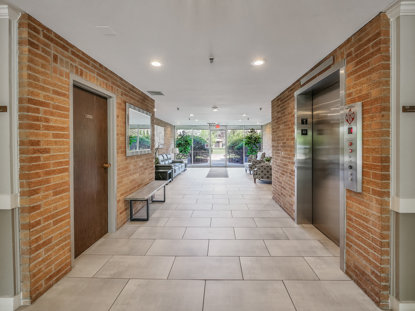 1747 West Crystal Lane, Unit 210 Mount Prospect, IL 60056 - Photo 6 of 33 a lobby with furniture and a potted plant